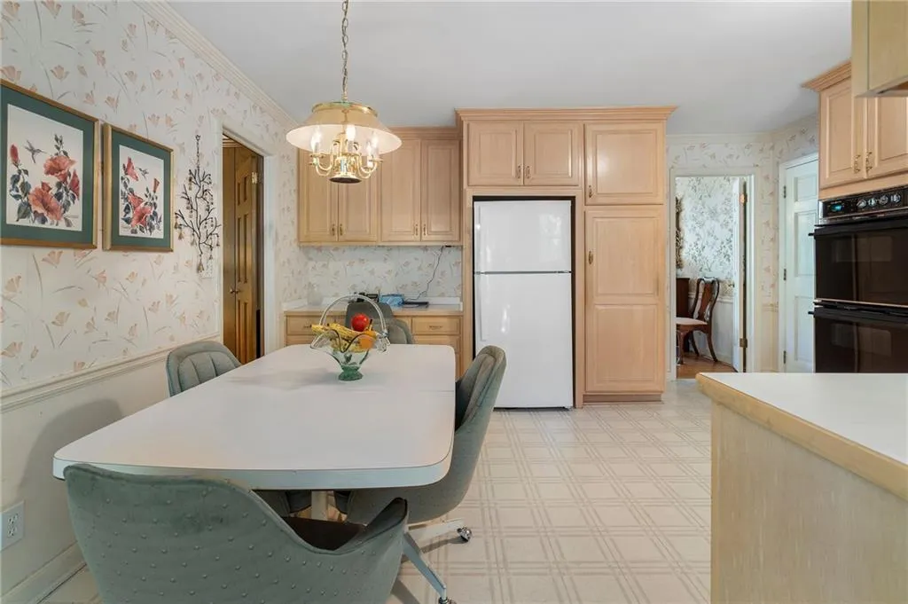 Dining area featuring ornamental molding and a notable chandelier