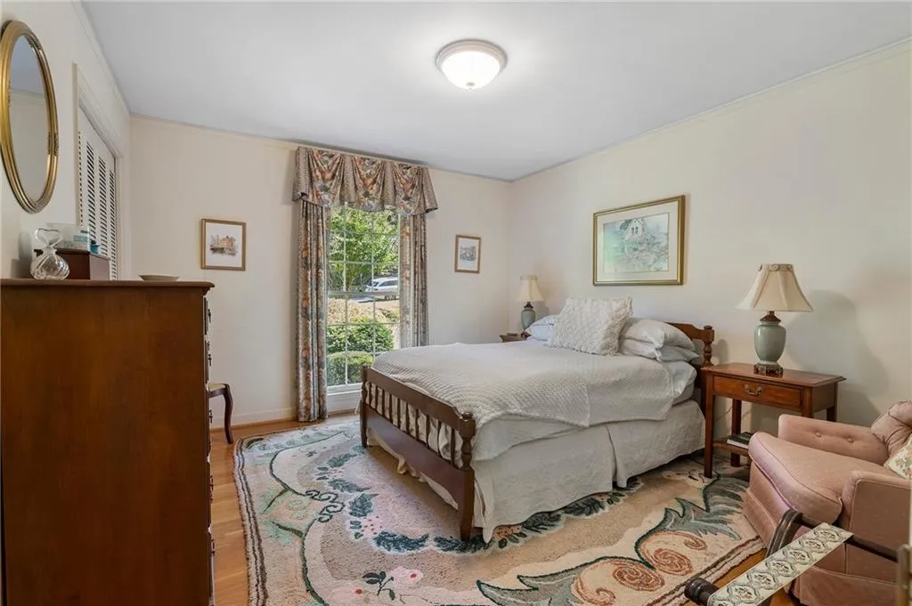 Bedroom featuring light hardwood / wood-style flooring and crown molding