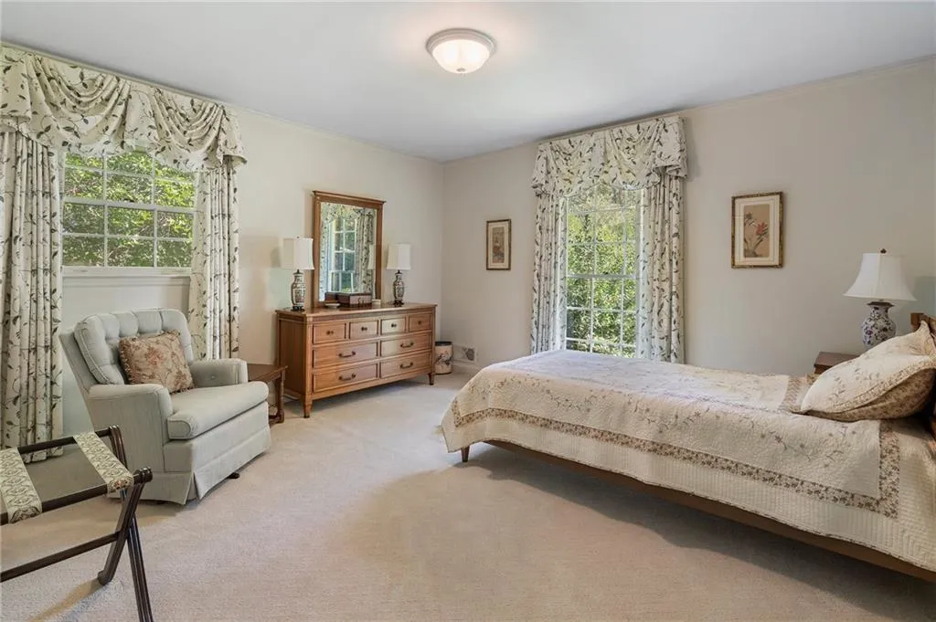 Bedroom featuring light colored carpet and ornamental molding