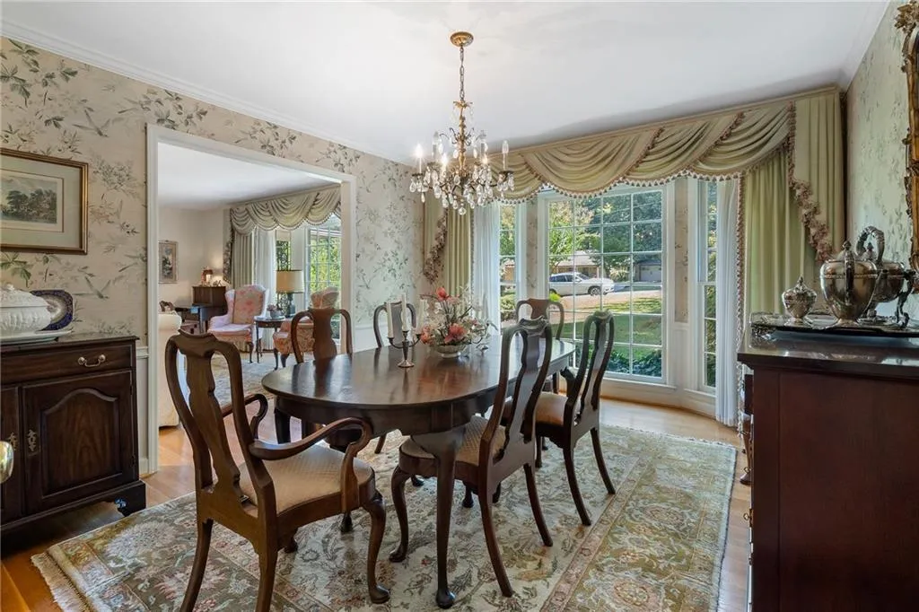 Dining space with an inviting chandelier, crown molding, and light hardwood / wood-style floors