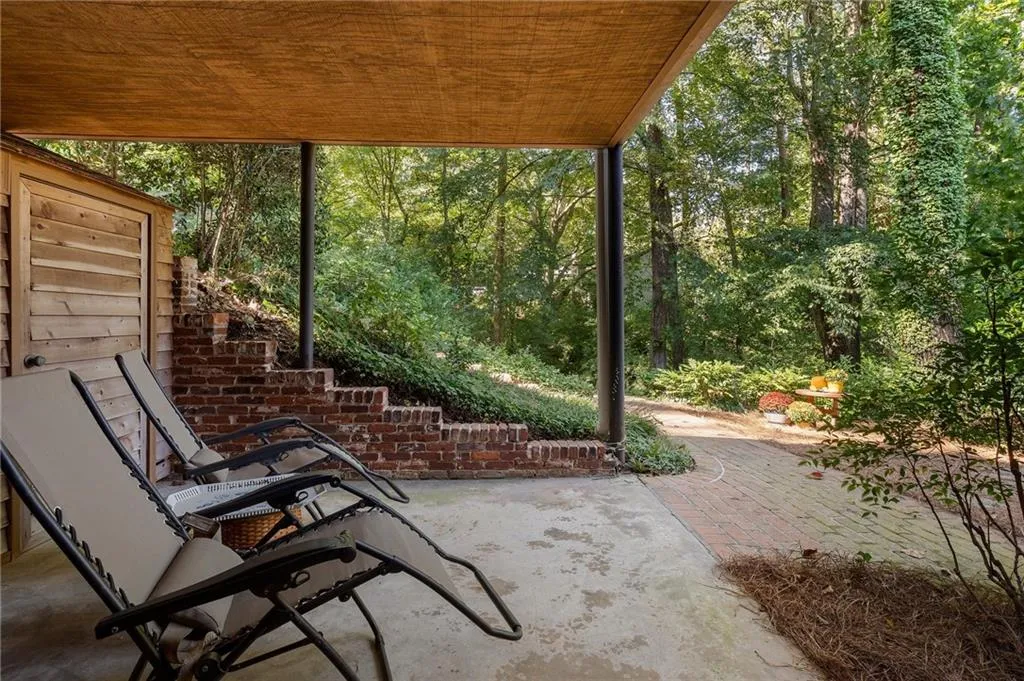 View of patio / terrace with two storage areas behind chairs for all of your lawn equipment.