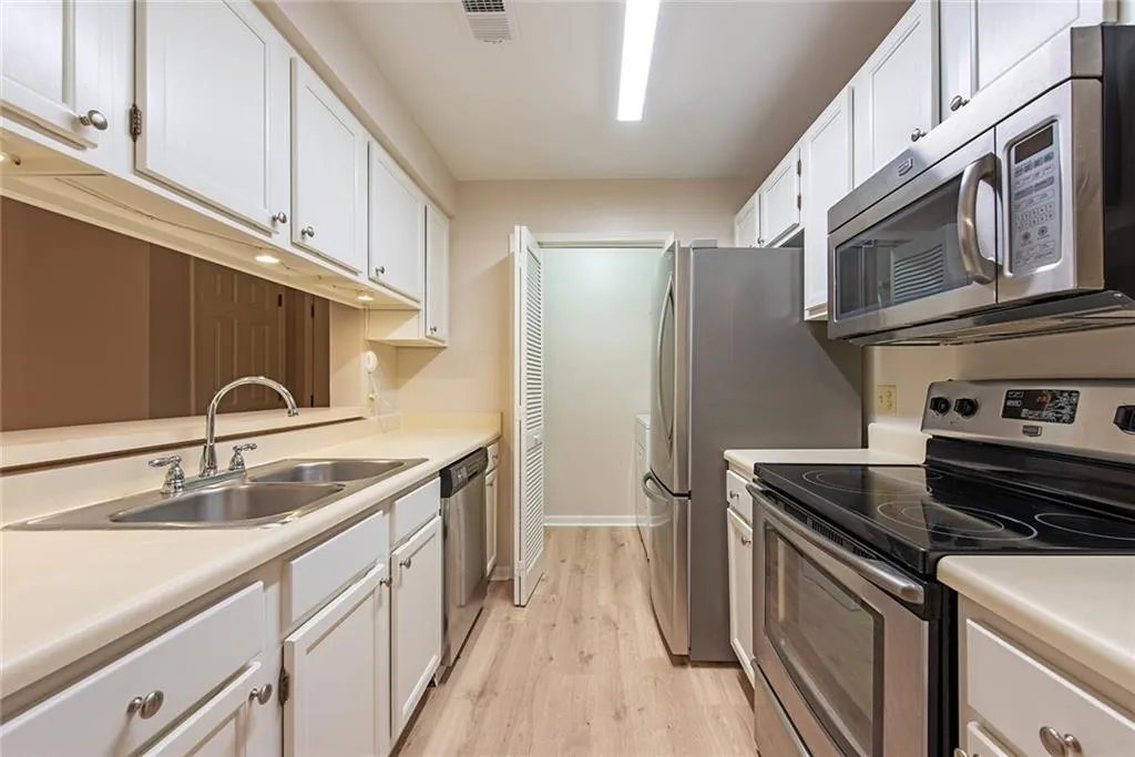 Door at end of kitchen opens into Laundry closet/pantry