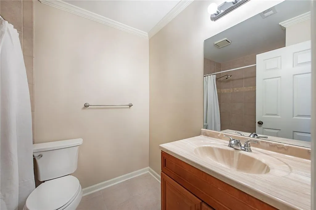 Bathroom has single vanity, mounted mirror
