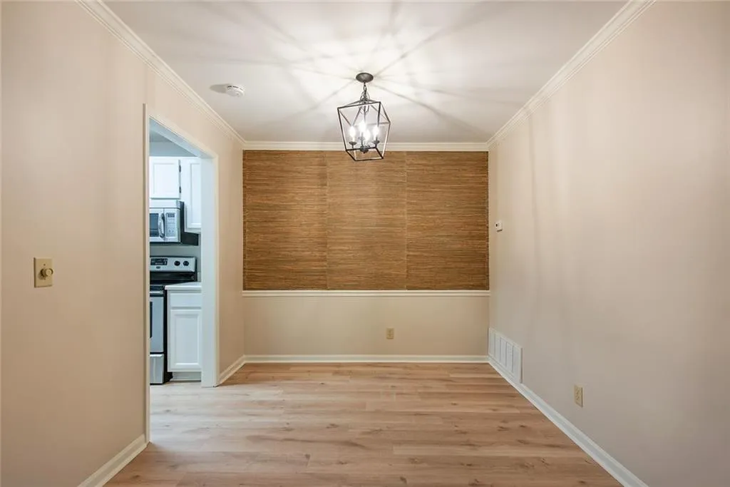 Dining area with on-trend glasscloth and updated chandelier