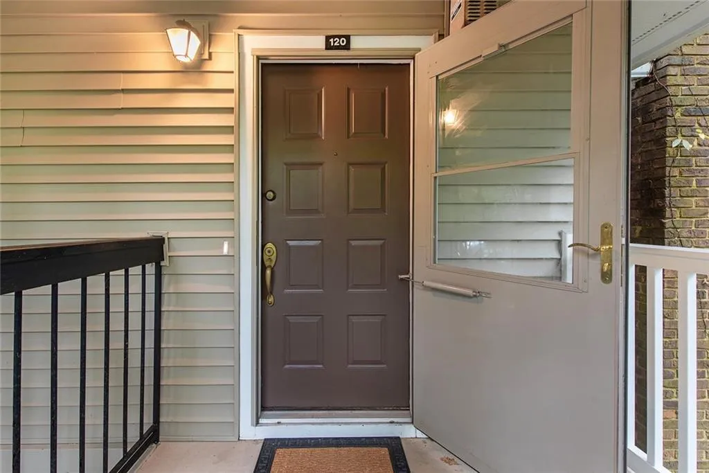 View of exterior entry.  Storm door with glass and solid front door.
