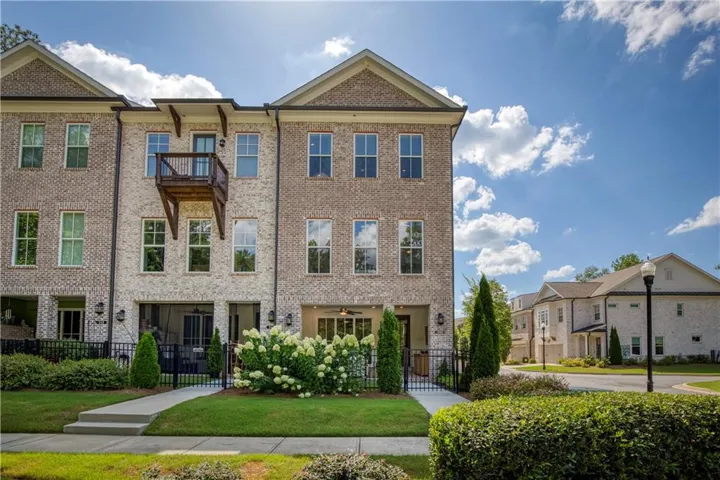 Welcome home to one of Atley's most coveted end-unit residences, perfectly positioned with rare privacy, beautiful landscaping, and peaceful wooded surroundings just moments from Downtown Alpharetta.
