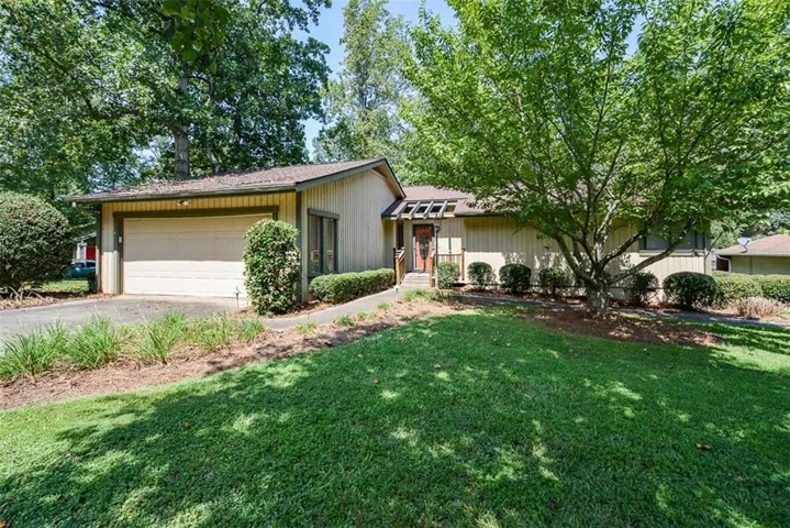 Single-story residence featuring a two-car garage with a paved driveway