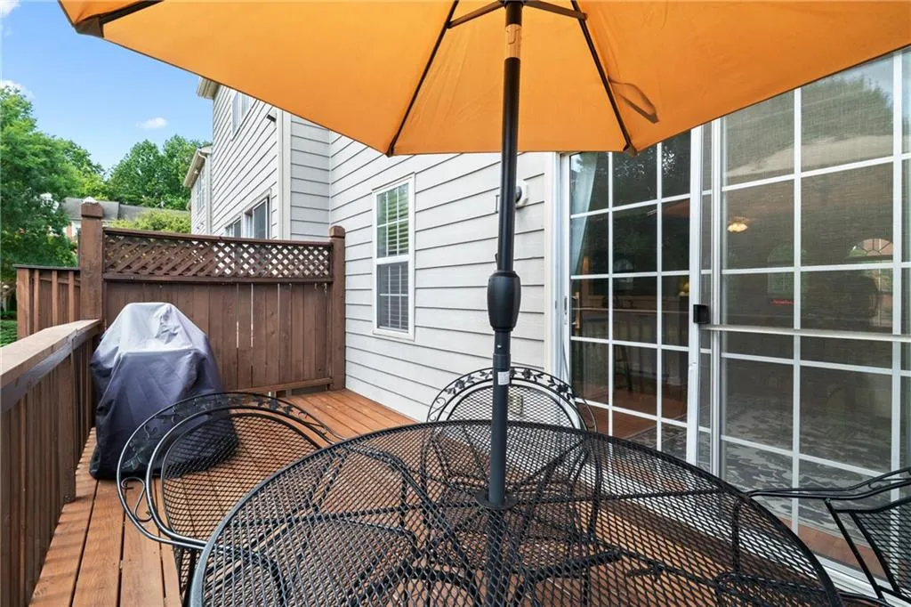Wooden terrace with outdoor dining space and grilling area