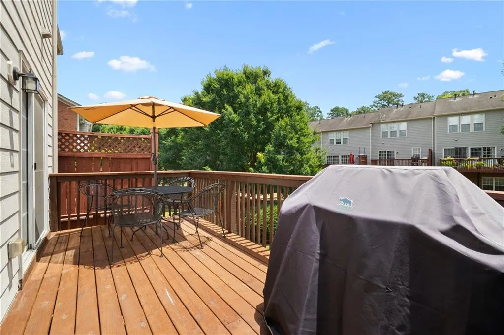 Wooden terrace featuring grilling area and outdoor dining space