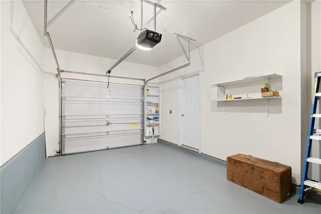 Garage featuring a garage door opener