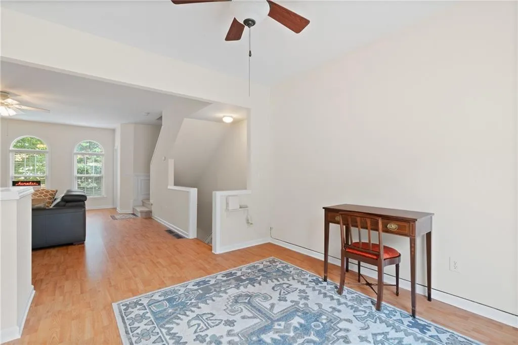 Living area featuring a ceiling fan and light wood-type flooring