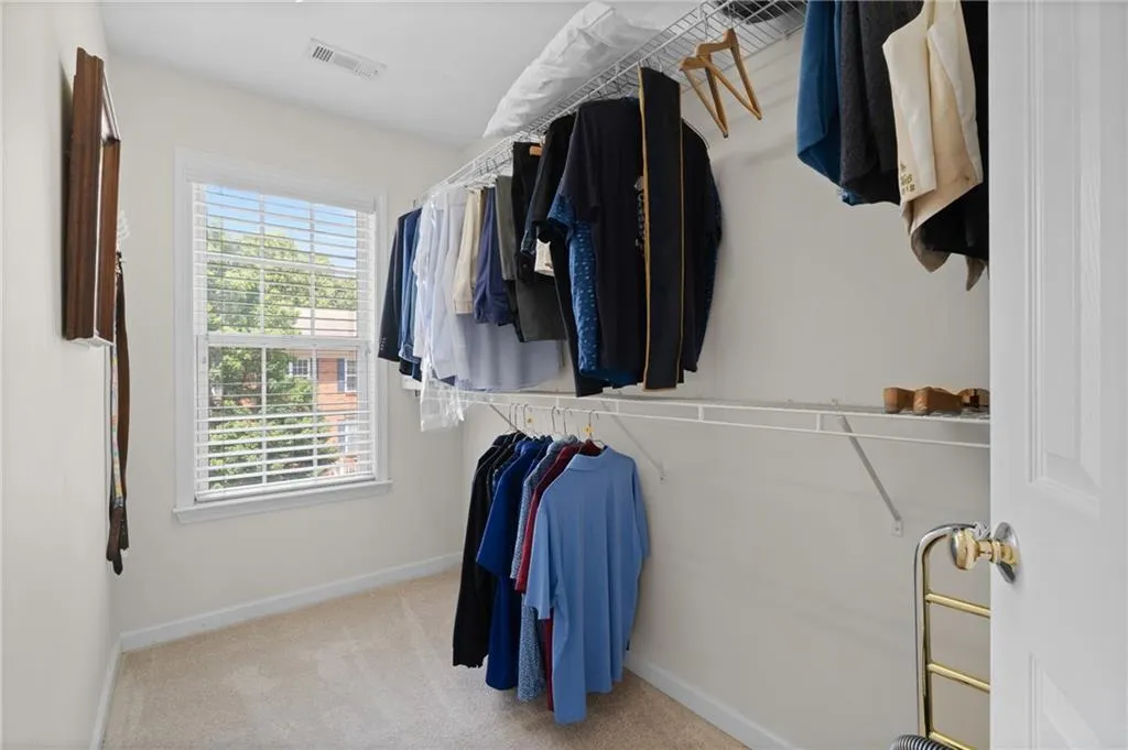 Spacious closet featuring carpet
