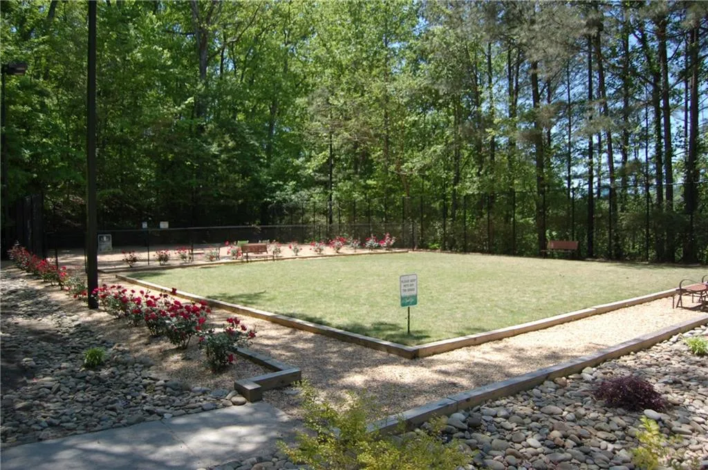 View of property's community featuring a yard and gated/enclosed dog park.