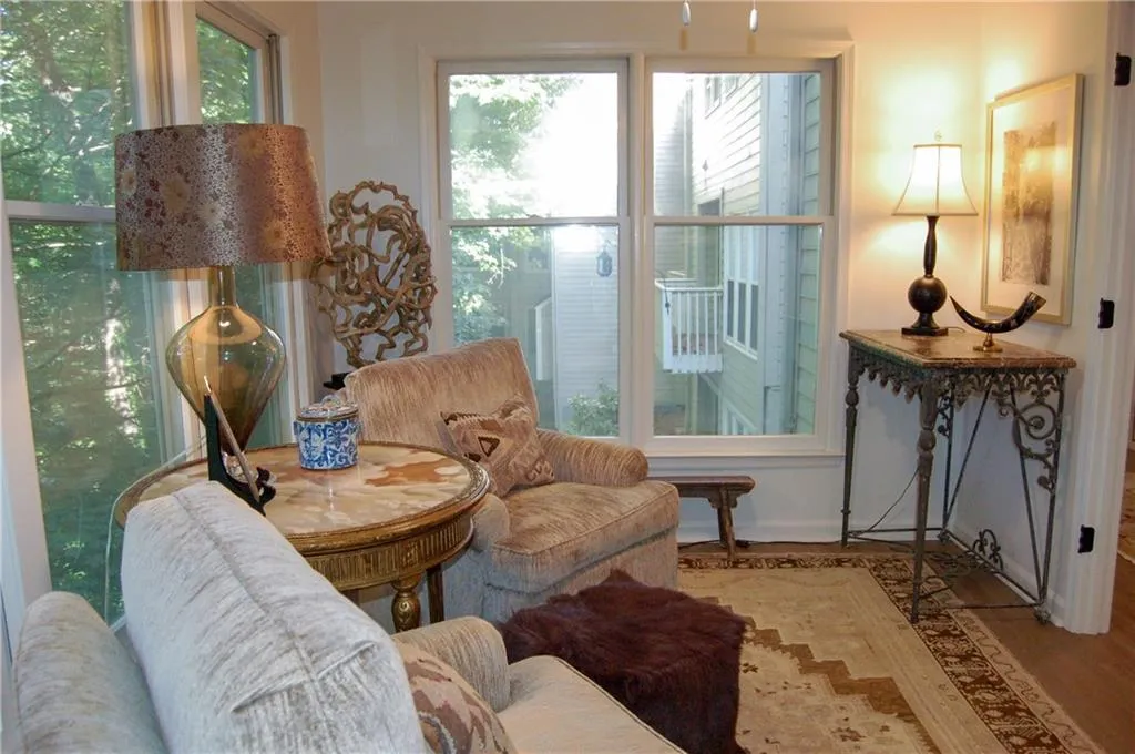 Sitting room featuring light wood-type flooring and a wealth of natural light