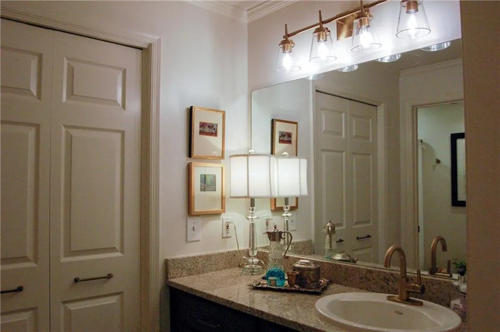 Bathroom featuring vanity and ornamental molding