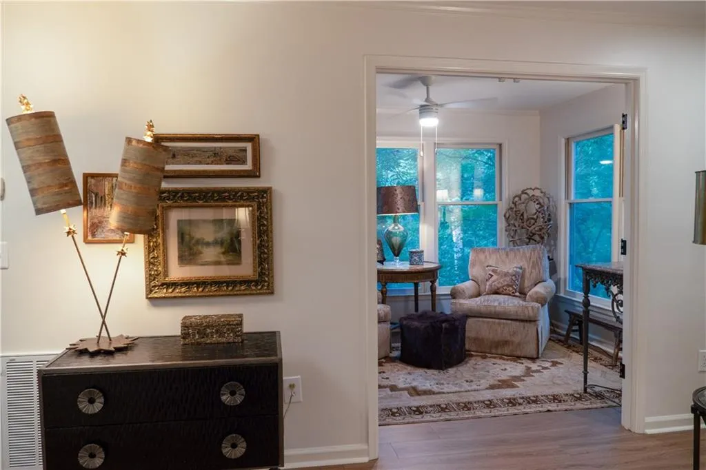 Foyer with ornamental molding and hardwood / LVT wood-style floors