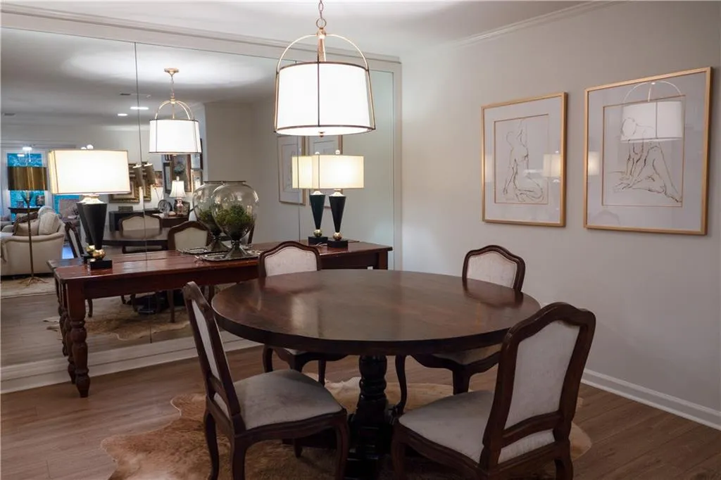 Dining space with crown molding and hardwood / wood-style flooring