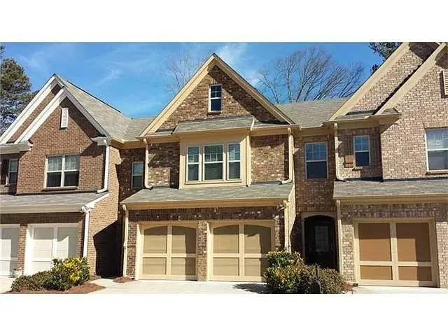 Brick exterior with multi-pane windows and a dormer window