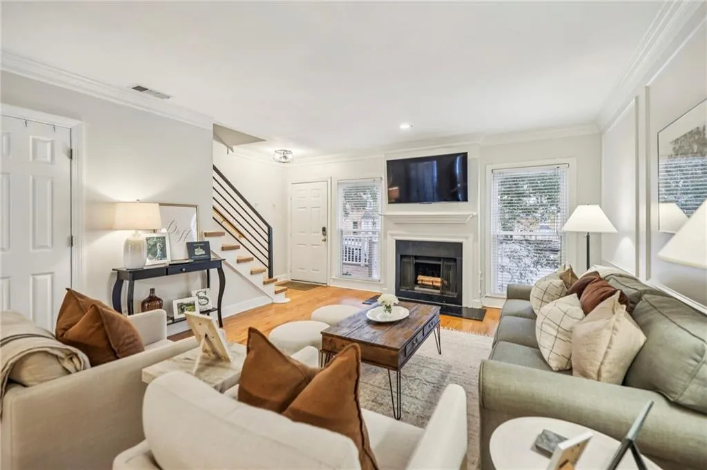 Warm and welcoming family room anchored by a charming fireplace.