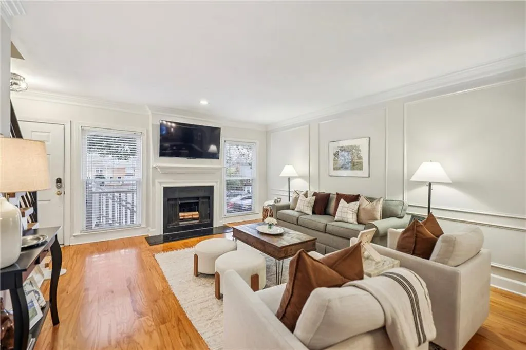 Fireplace flanked by windows that flood the space with natural light.
