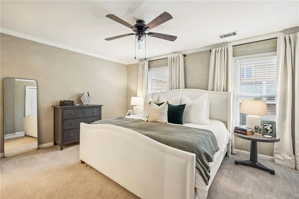 Primary bedroom offering generous space and gentle natural light.