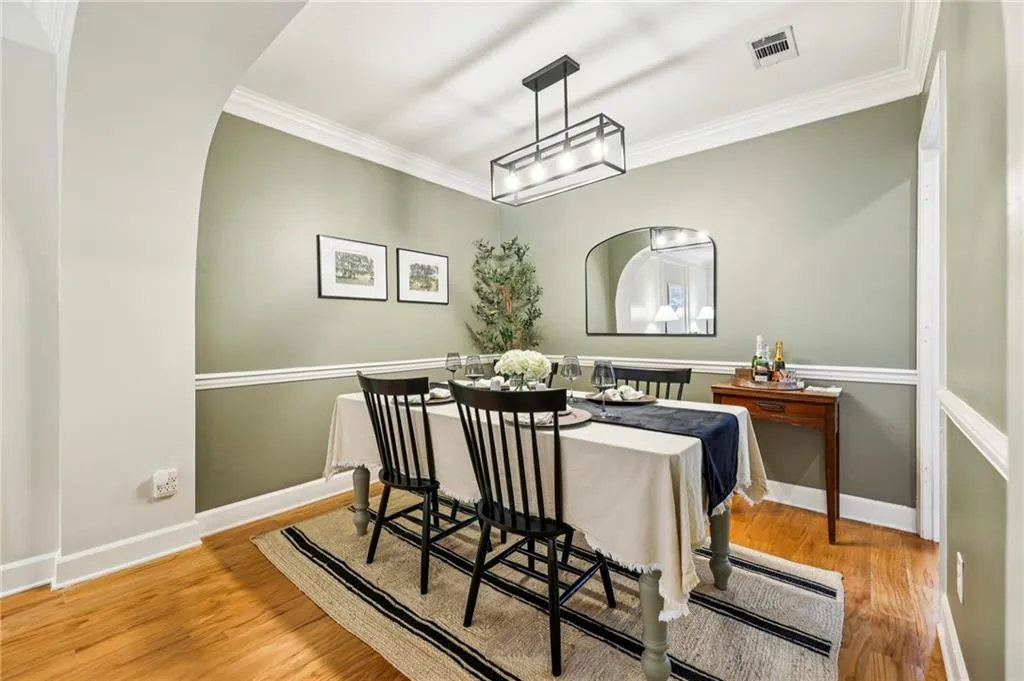 Tastefully detailed dining area with chair rail and crown molding.