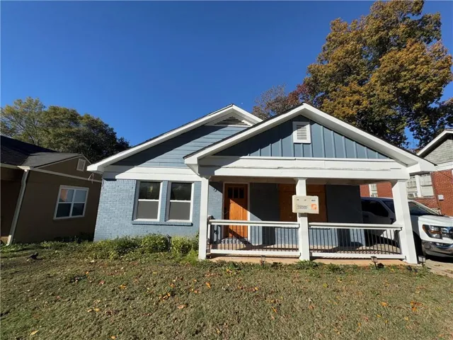 Blue siding and brick exterior with white trim