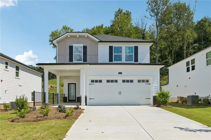 Contemporary-style exterior with a covered porch entry, attached garage, and a concrete driveway