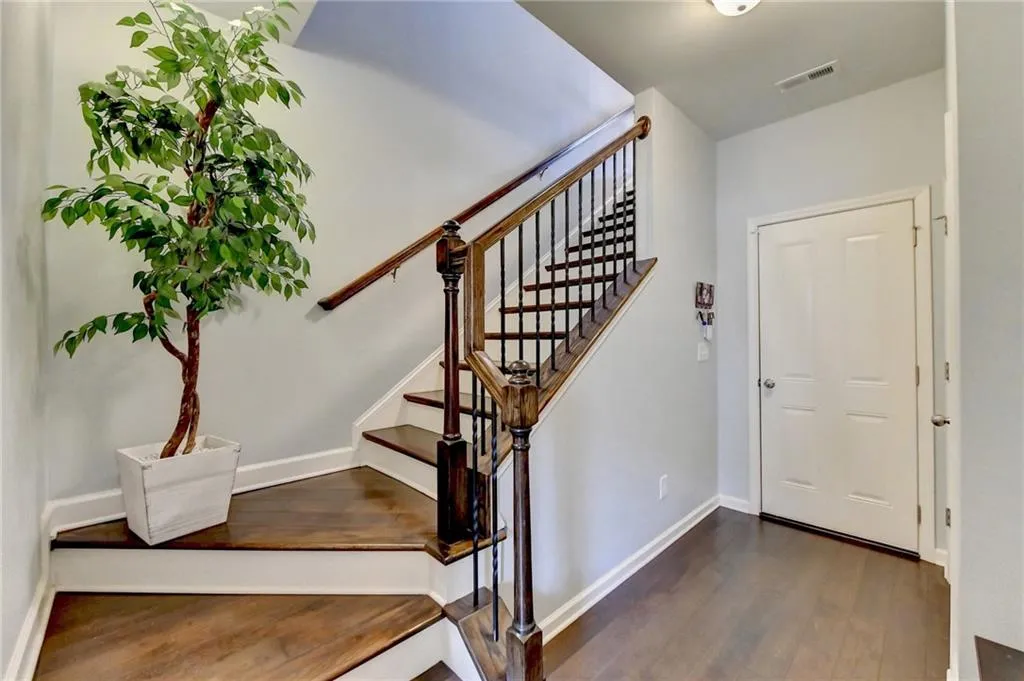 Staircase featuring dark hardwood / wood-style flooring