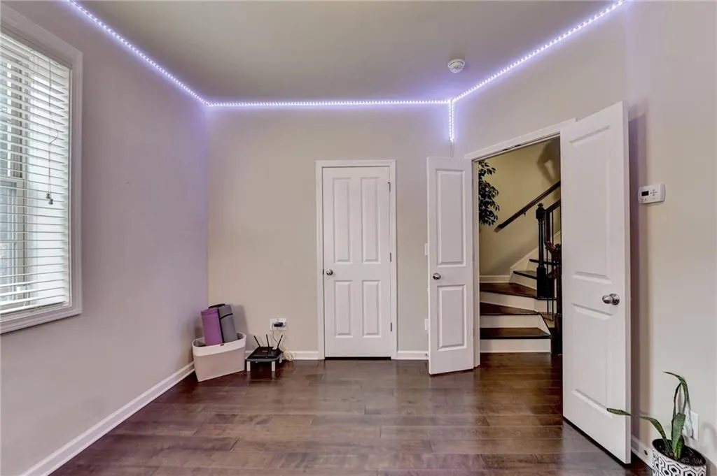 Bedroom with dark hardwood / wood-style floors