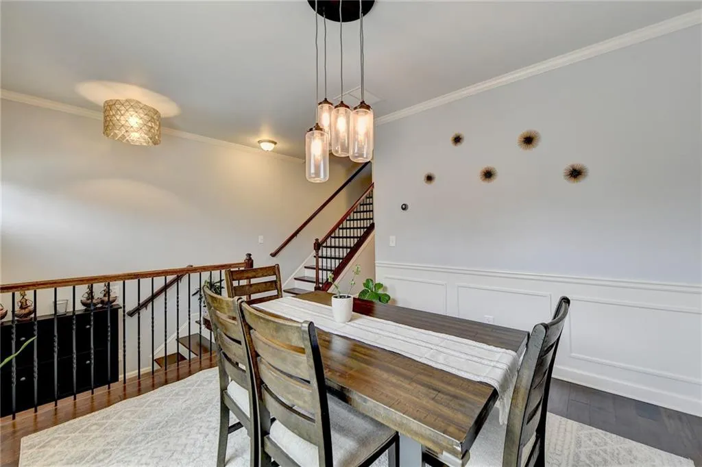 Dining space featuring dark hardwood / wood-style flooring and crown molding