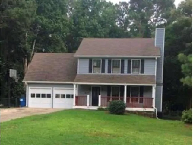 Two-story residence featuring covered front porch