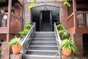 View of exterior entry featuring brick siding