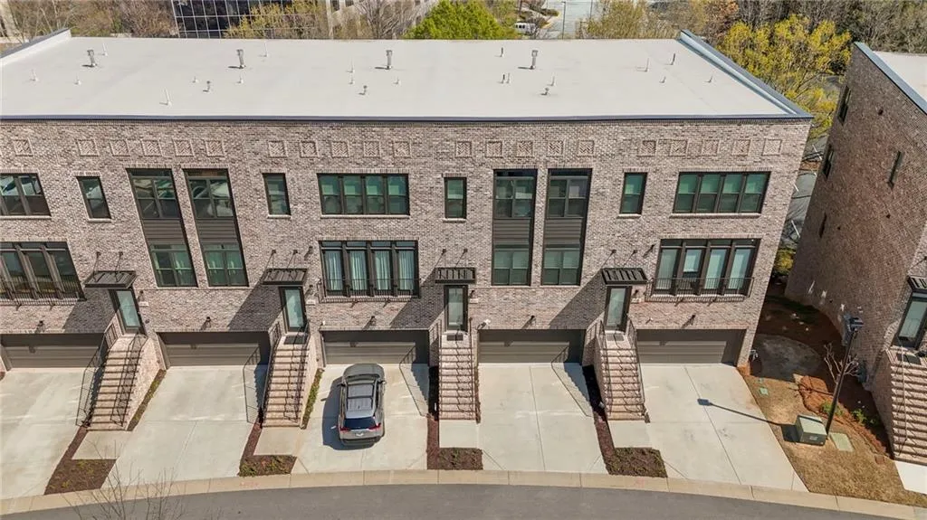 View of apartment building / complex with a garage and driveway