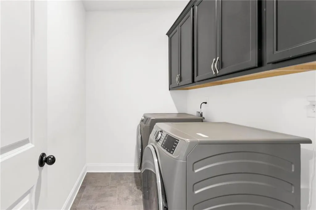 Laundry area with separate washer and dryer and cabinet space