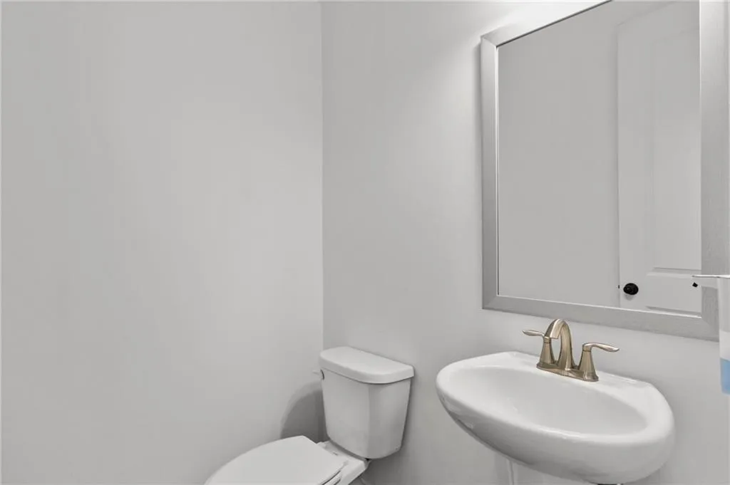 Half bath featuring toilet and a sink