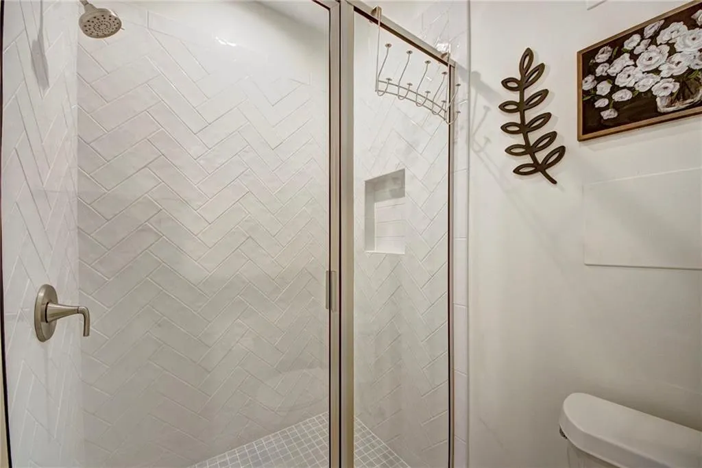 Full bathroom with a shower stall and toilet