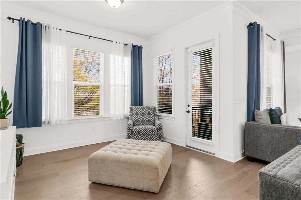 Living area featuring crown molding and wood-type flooring