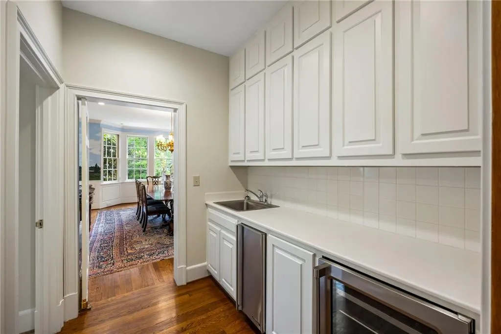 Convenient butler's pantry between the kitchen and dining room with beverage fridge and lots of storage
