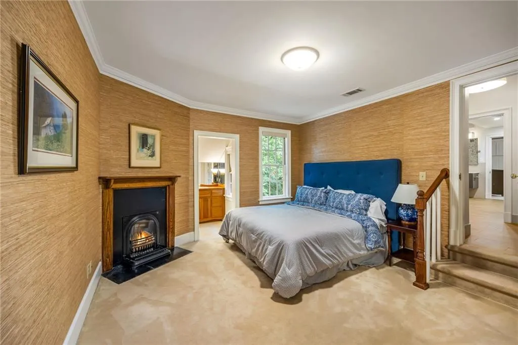 Guest room with decorative original fireplace, walk in closet and direct bath access