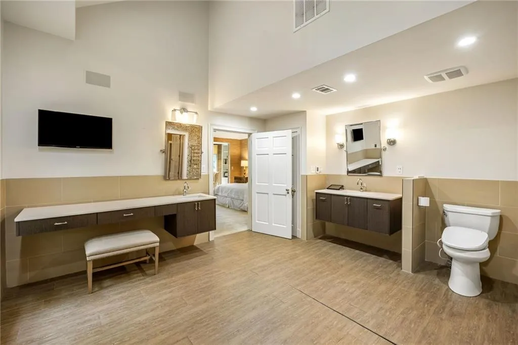 So sleek. Bidet toilet, television, accessible vanities, warm floor and skylights-you have it all.