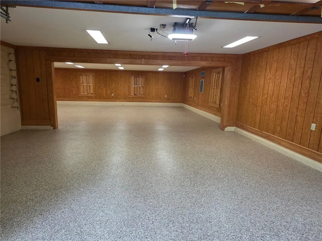 Another section of the garage. There are garage doors on two sides. perfect for a home business, exercise studio, art workshop, any type of collections or a fun party room!