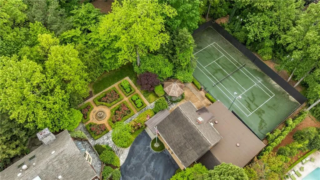 Note the gazebo and parterre garden. Property extends beyond the tennis court in the back. There is a perfect place in the backyard on the left of the house and garden for a pool or big playground. There is already a treehouse!