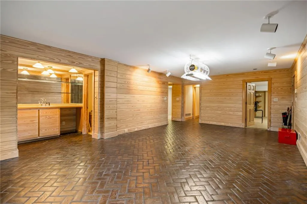 Perfect mancave!. Opens to the two car garage plus storage, mechanicals and full bath