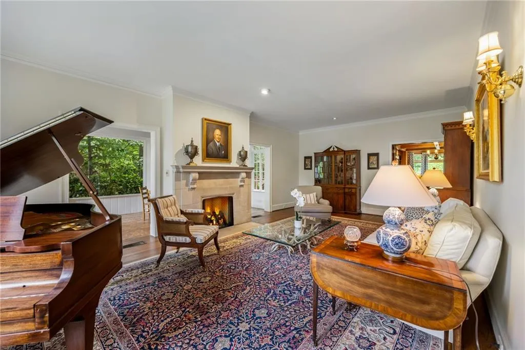 Fireside living room for quiet conversation opens to sunroom. Lots of windows in every room to enjoy the magnificent landscaping and let the outside in.