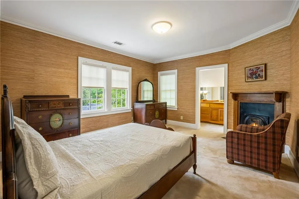Second guest room with big walkin closet, decorative fireplace and direct bath access
