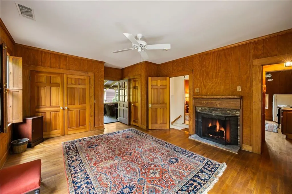 Bedroom of the carriage house apartment with another fireplace also opens to the porch.
