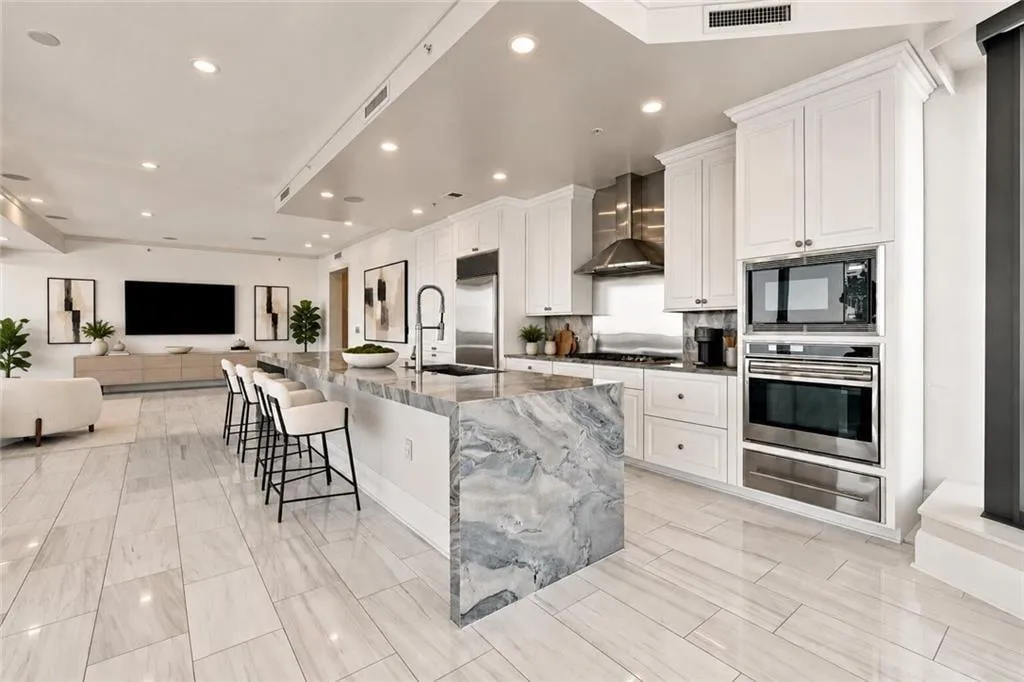 Remodeled gourmet chefs kitchen with Wolf-Subzero appliances, marble island and counters