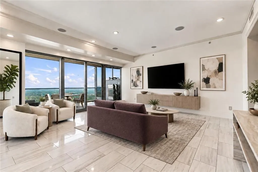Open concept family room area with polished porcelain tile floors