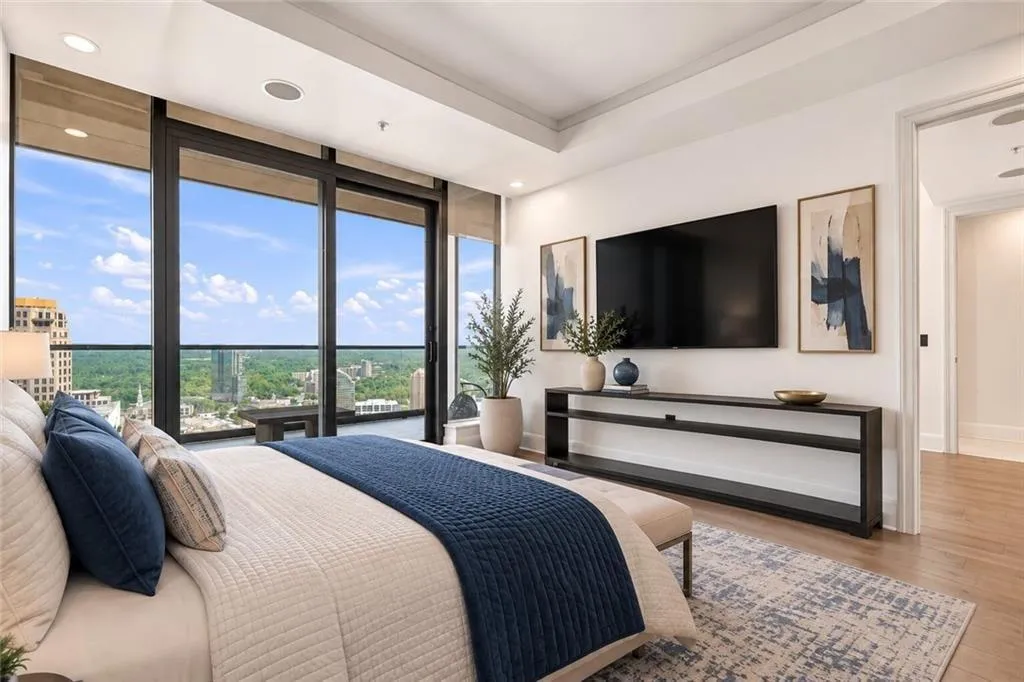Master suite with tray ceiling, under lighting, skyline, and mountain views